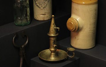 Victorian items including stoneware hot water bottles, chamberstick, candle snuffer and shoe