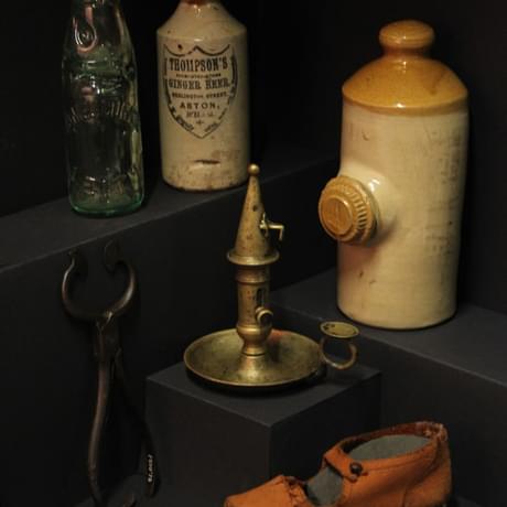 Victorian items including stoneware hot water bottles, chamberstick, candle snuffer and shoe