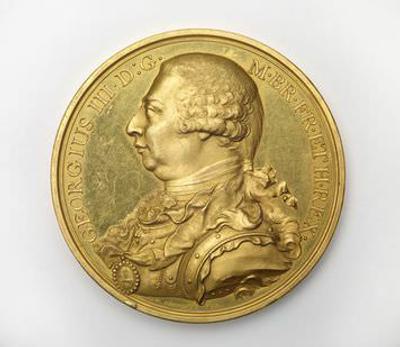 A photograph of an old gold coloured coin