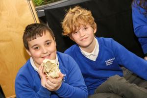 Two school children one of which is holding a skull