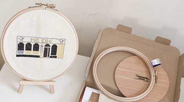 Cross Stitch set including finished work and box with items inside.