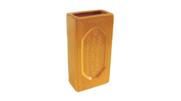 Yellow vase in the shape of a brick.