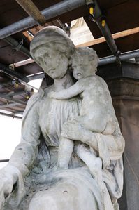 Charity figure with child after first clean with some dirt still showing.