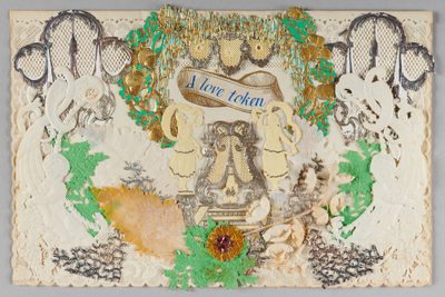 Intricate lace design with two figures, floral accents, and "A love token" banner.