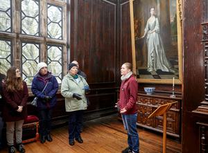 A small group of people admiring something out of view in an art gallery