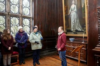 A small group of people admiring something out of view in an art gallery