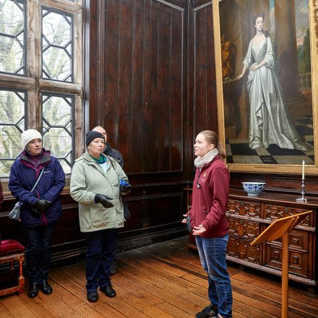 A small group of people admiring something out of view in an art gallery
