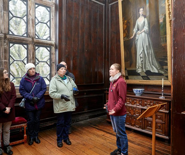 A small group of people admiring something out of view in an art gallery