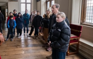 A group of adults and children on a tour.