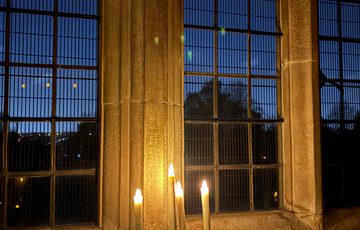 Window lit by 3 candles.