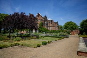 Pathway, grass and trees in the garden, with Aston Hall Jacobean house in background.