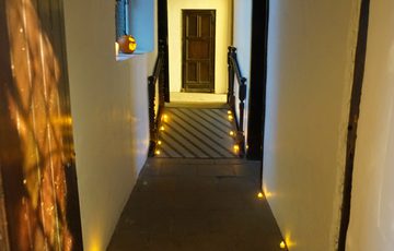 A hallway with halloween orange lighting.