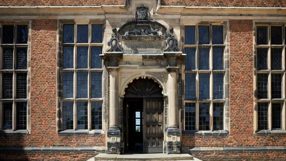 Front entrance of a Jacobean Hall with ornate stonework surround