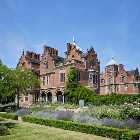 Exterior view of the rear of a Jacobean Hall and flower garden
