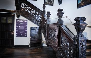 Dark wooden ornate staircase.