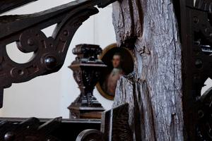 A wooden staircase with a semi-circular shaped hole in part of it.