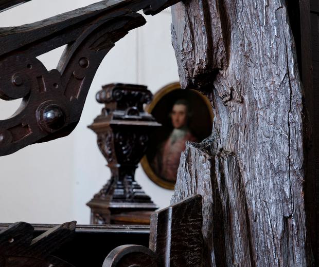 A wooden staircase with a semi-circular shaped hole in part of it.