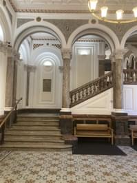 Entrance stairs with ornate staircase.