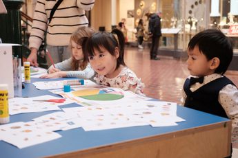 Children sitting at a table doing an activity.
