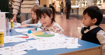 Children sitting at a table doing an activity.