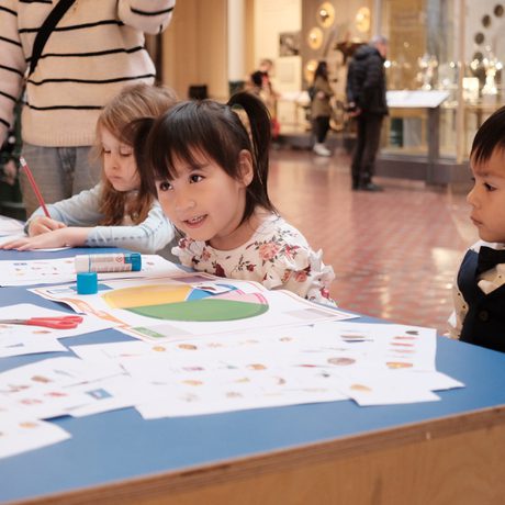 Children sitting at a table doing an activity.