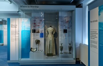 A dress and accessories on display.