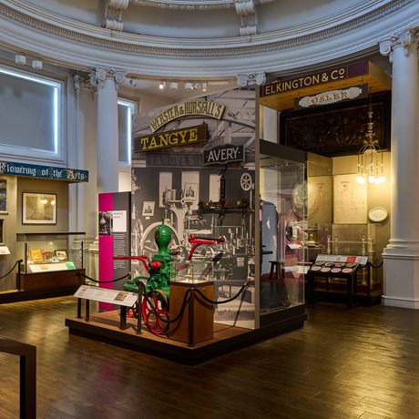 A circular gallery with historic pump on display.