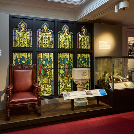 A large stained glass window on display.