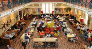 Busy museum café viewed from above.