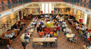 Busy museum café viewed from above.