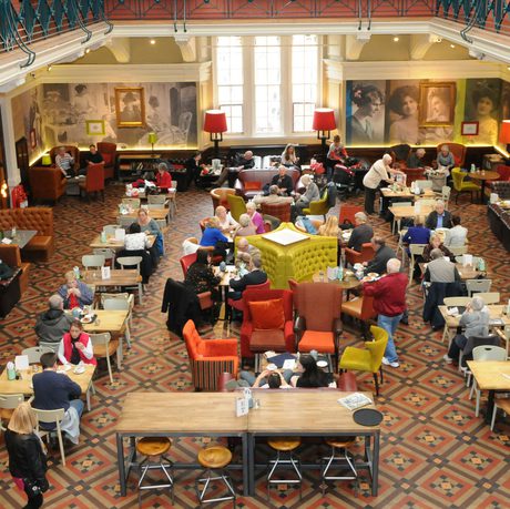 Busy museum café viewed from above.