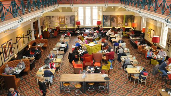 Busy museum café viewed from above.