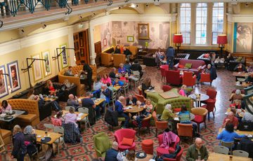 A busy museum tearoom viewed from above.