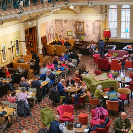 A busy museum tearoom viewed from above.