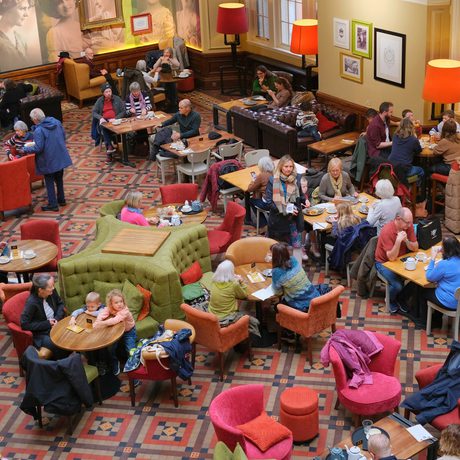 A busy museum tearoom viewed from above.