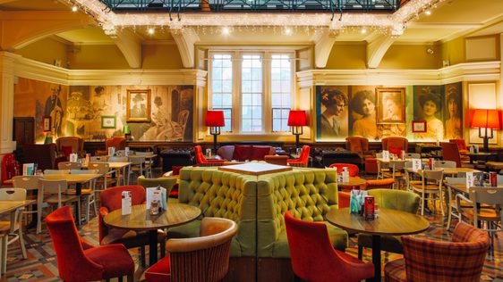 The tearoom space with table, chairs, sofa's and booths with icicle lights hanging.