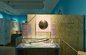 A display case featuring swords and shields.