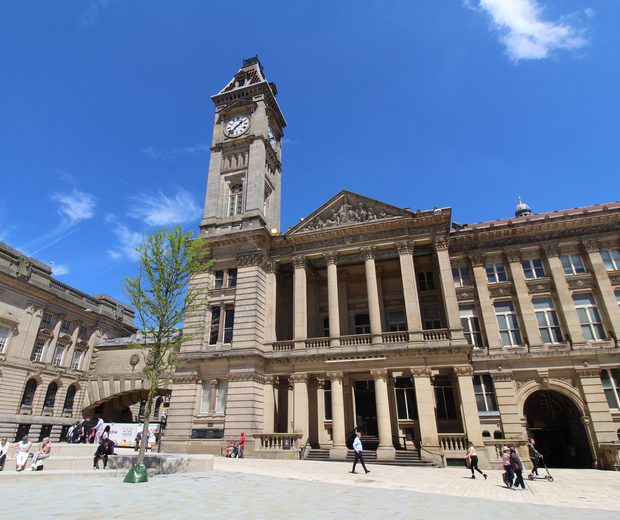 Museum building with tall columns at the entrance and clock tower.