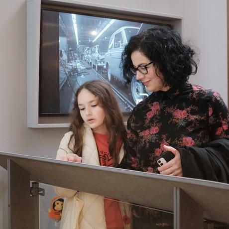An adult and child looking at a display label.