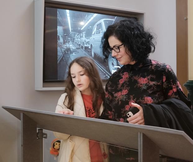 An adult and child looking at a display label.