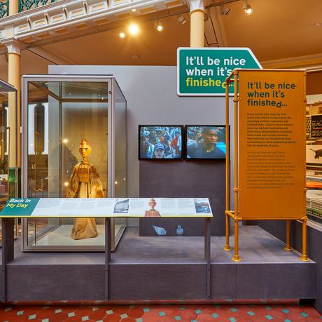 A display of objects including puppet and two TV screens