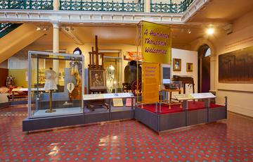 A display of 'A Hundred Thousand Welcomes' featuring a mix of items from costume and typewriter to paintings.