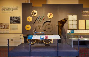 Display of 'Bits and Bobs' including bicycle, wheel, ironwork and glass window.