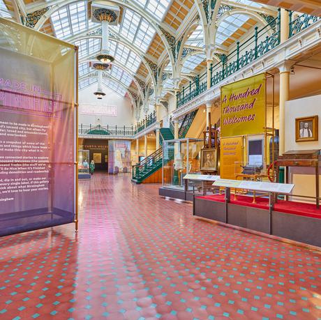 The Industrial Gallery, a large ornate gallery with ironwork arches and large glazed roof windows showing a display based on Made In Birmingham.