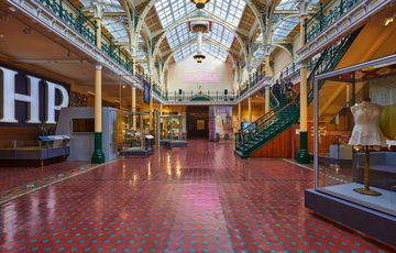 The Industrial Gallery, a large ornate gallery with ironwork arches and large glazed roof windows showing a display based on Made In Birmingham.