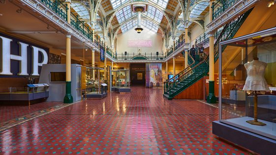The Industrial Gallery, a large ornate gallery with ironwork arches and large glazed roof windows showing a display based on Made In Birmingham.