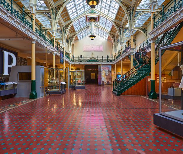The Industrial Gallery, a large ornate gallery with ironwork arches and large glazed roof windows showing a display based on Made In Birmingham.