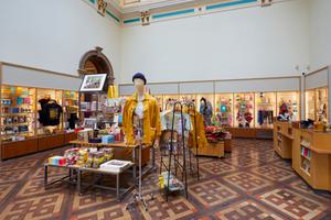 Museum shop featuring a variety of shop artefacts including clothes, prints and more.