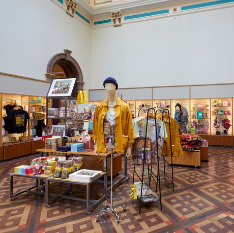Museum shop featuring a variety of shop artefacts including clothes, prints and more.