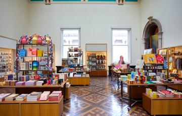Shop items on display in a museum shop including booking and stationary.